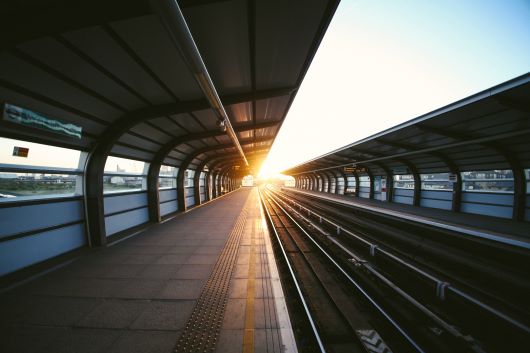 Empty train station with sun flare